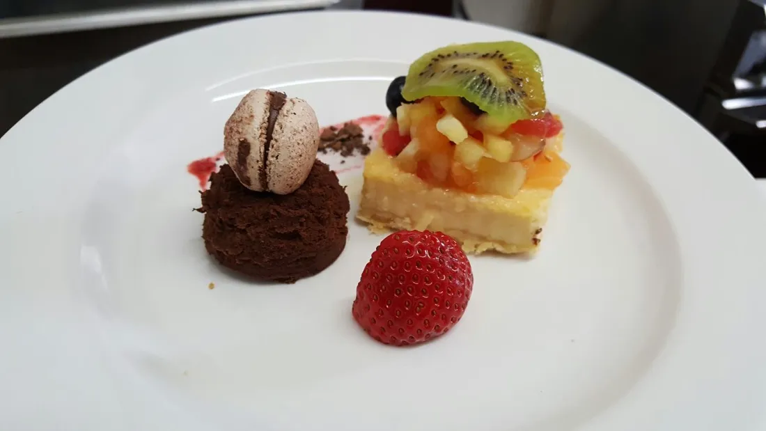 Plated chocolate mousse, macaron and fruit tart