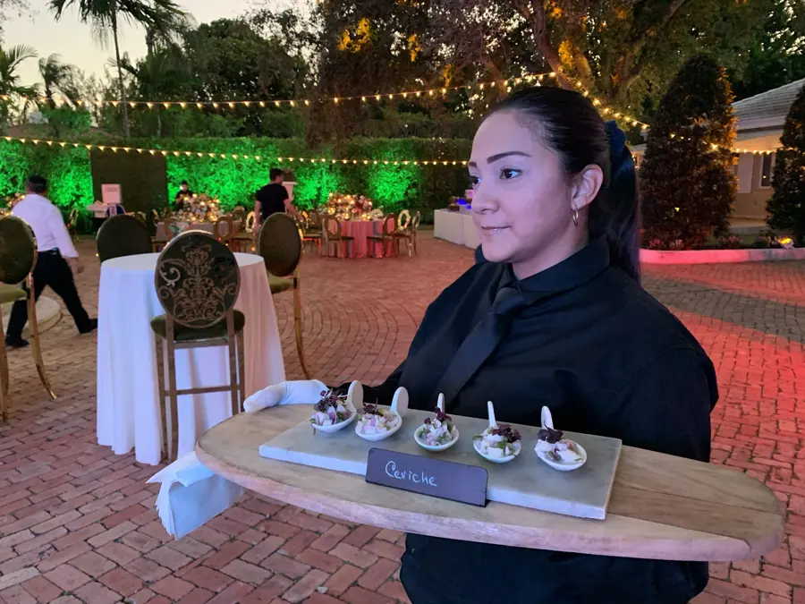 Passing ceviche at a garden reception