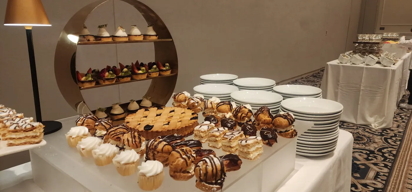 Dessert table with pastries, tarts and cream puffs