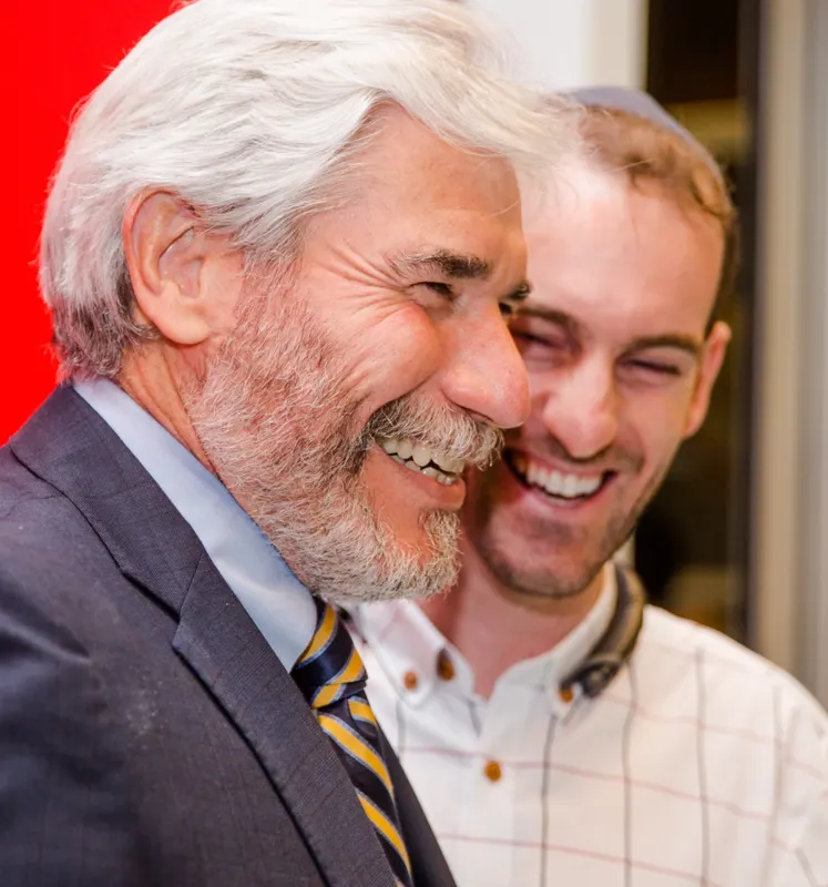 Chef Shaike laughing with the president of a leading Jewish Federation organization