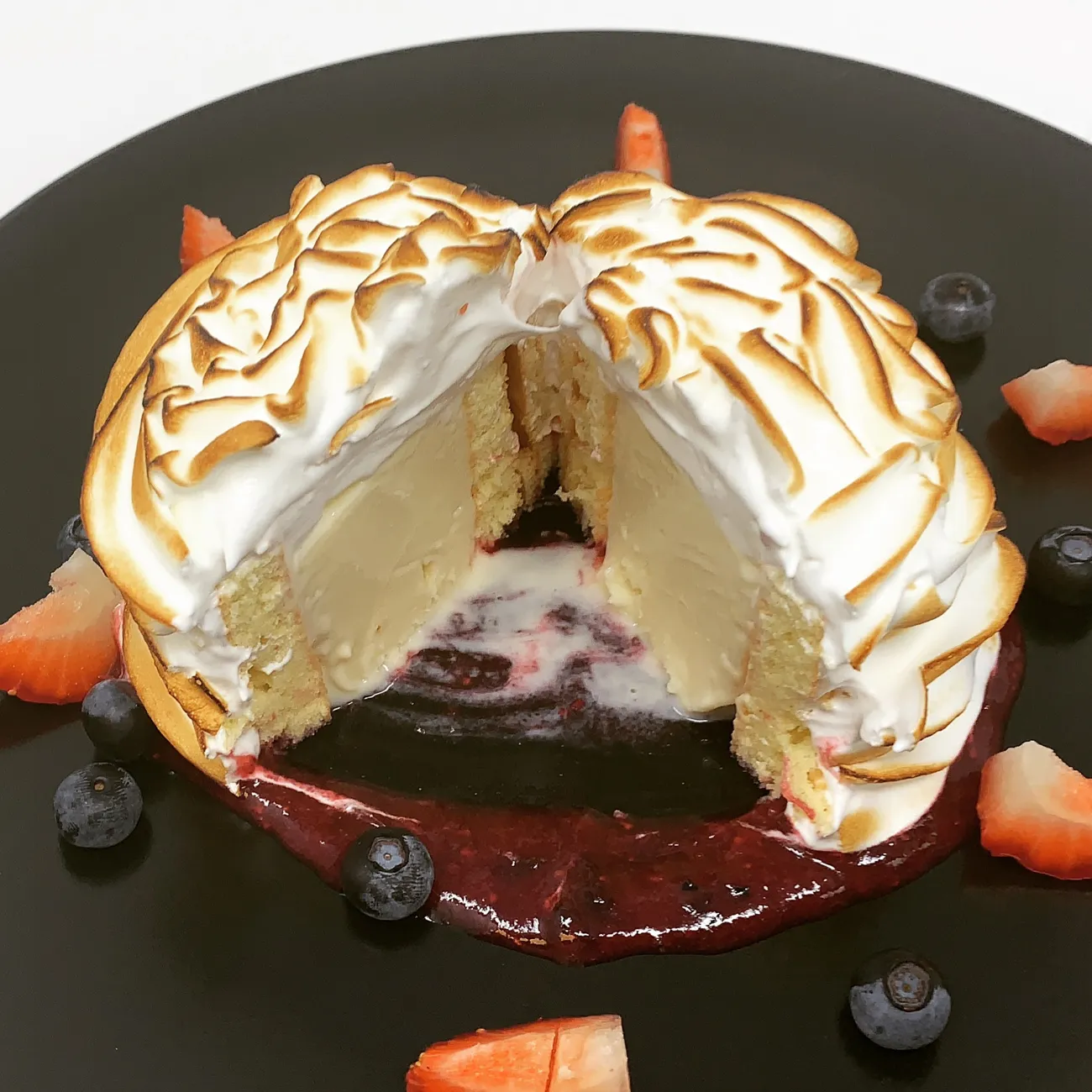 Baked Alaska with toasted meringue and berry sauce